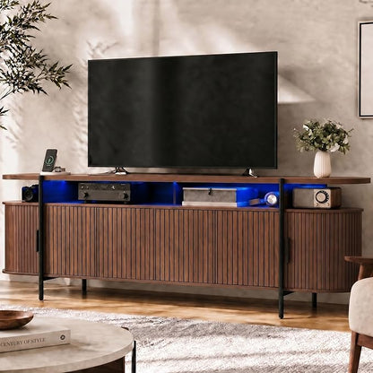 69" Mid Century Modern TV Stand, Curved Entertainment Center with LED Light & Power Outlet, Fluted Wood TV Stand for TVs up to 80'',Media TV Console Table with Sliding Doors for Living Room, Walnut